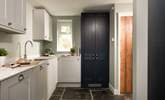 The greys and blues of the modern kitchen blend perfectly with the fabulous flagstone floor. - Thumbnail Image