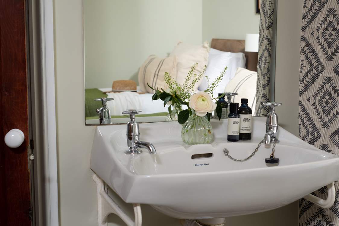 There is a little vanity unit in the bedroom.