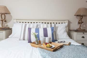 Bedroom one offers a king-size bed, comfy furnishings, and an en suite shower-room.