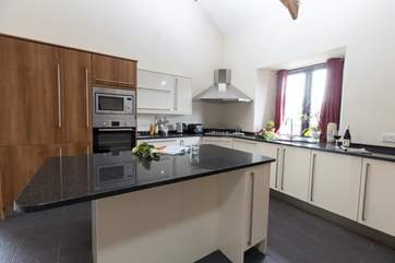 The kitchen offers oodles of space and is fully equipped with everything you will need to whip up a feast.