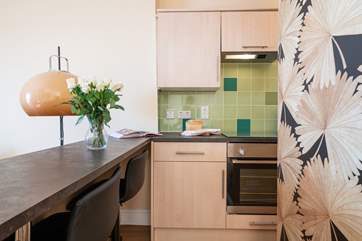 The breakfast-bar and kitchen is cleverly laid out.