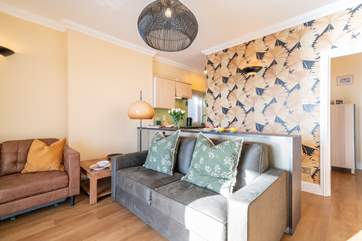 The modern style open plan living-room with small kitchen-area.
