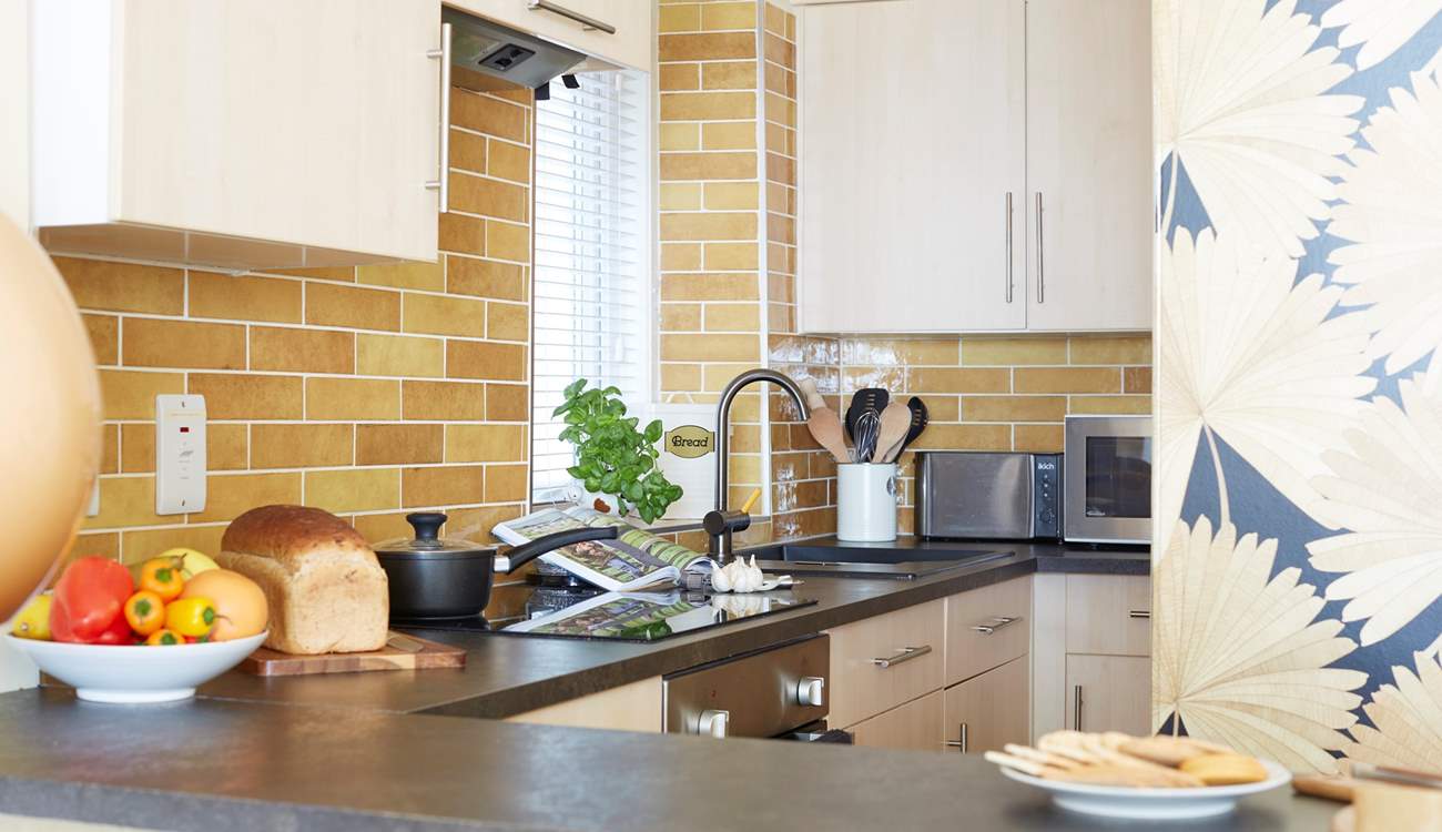 The breakfast-bar and kitchen is cleverly laid out. 
