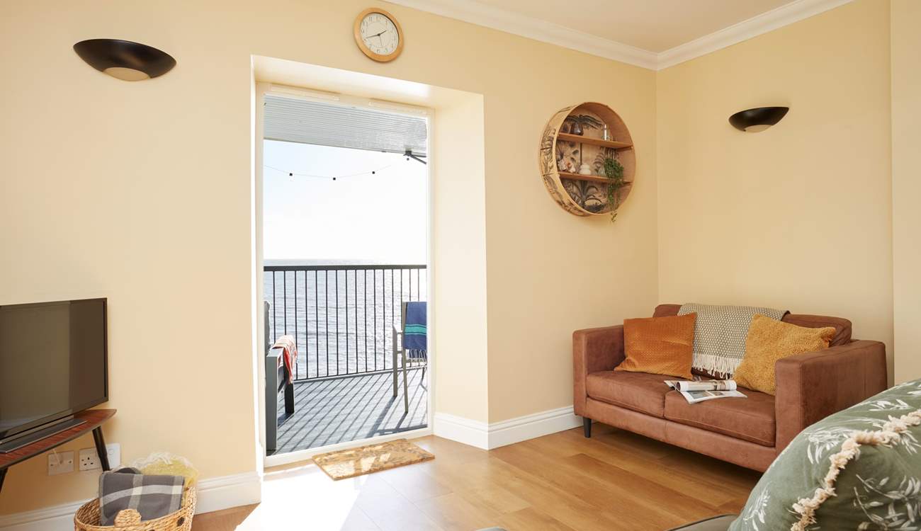 The modern style open plan living-room with views of the sea.