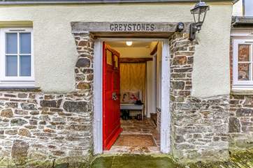 The red front door leads to Greystones.