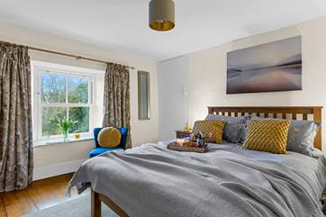 The main bedroom has a pretty colour scheme in soft muted tones.