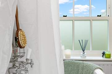 The luxurious bath has a shower over.