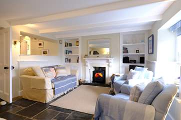 The delightful living-room is beautifully decorated in muted pastel shades.