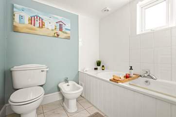The ground floor bathroom has a bath with hand shower attachment, ideal for salty toes.