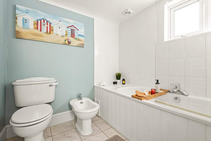 The ground floor bathroom has a bath with hand shower attachment, ideal for salty toes.