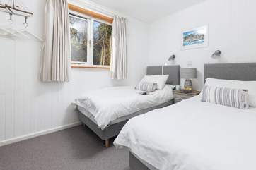 The second twin bedroom is decorated in muted shades.