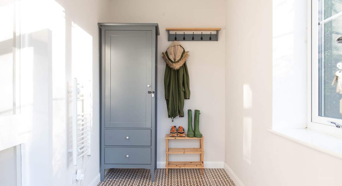 Three steps lead up to the lovely sunny porch. perfect for muddy boots and all of your beach bits and bobs. 