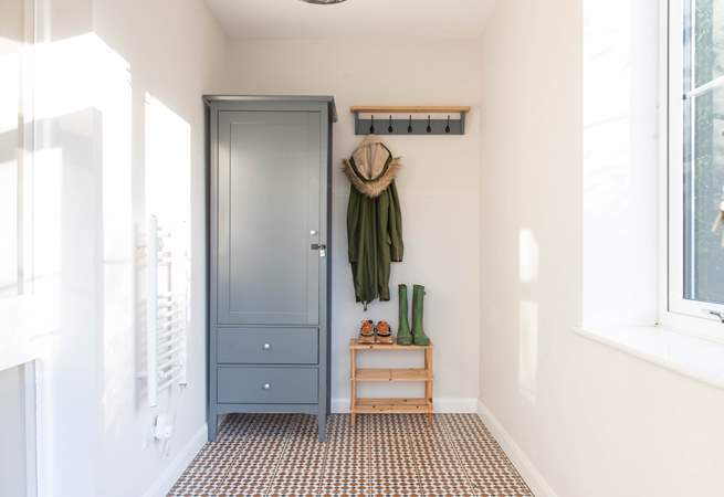 Three steps lead up to the lovely sunny porch. perfect for muddy boots and all of your beach bits and bobs. 