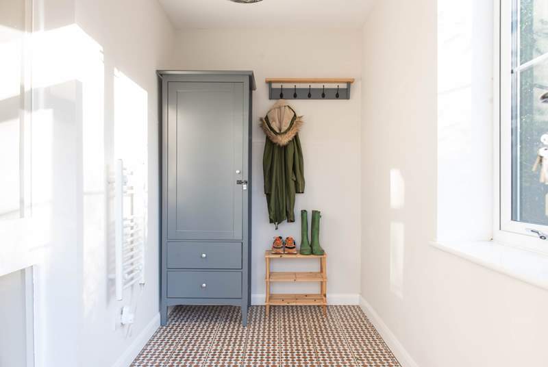 Three steps lead up to the lovely sunny porch. perfect for muddy boots and all of your beach bits and bobs. 
