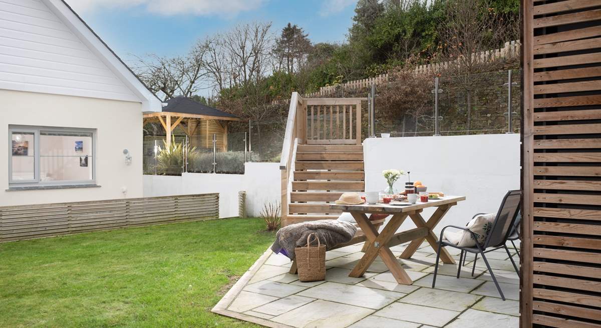 Ten decked steps lead down to the garden area, which is a lovely space to enjoy al fresco dining. 