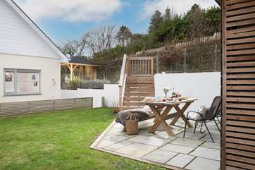 Ten decked steps lead down to the garden area, which is a lovely space to enjoy al fresco dining.
