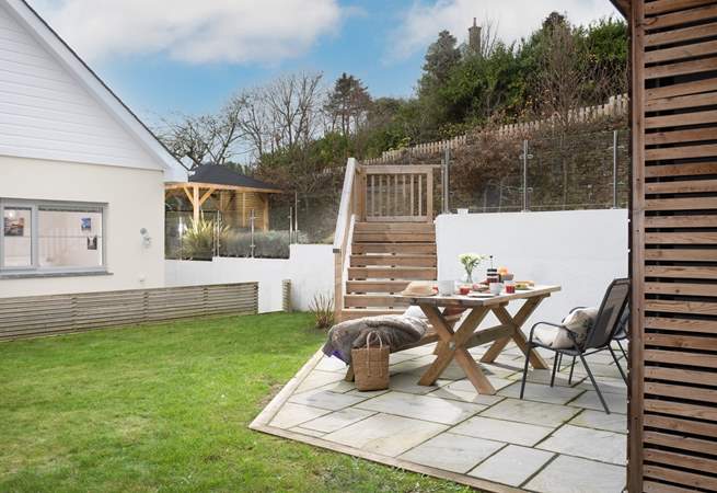 Ten decked steps lead down to the garden area, which is a lovely space to enjoy al fresco dining. 