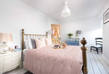 Pretty as a picture, the double bedroom has a dreamy brass bedstead and reclaimed floorboards to add to the charm.