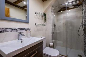The bathroom has a large shower.
