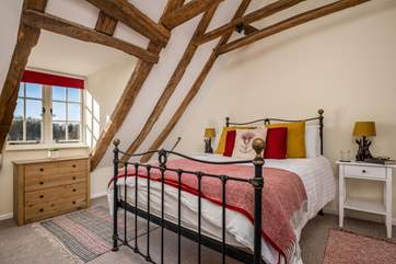 The gorgeous bedroom has a standard double bed and beautiful wrought iron bedstead.