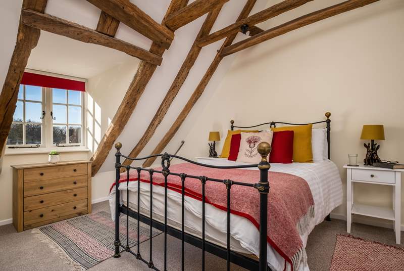 The gorgeous bedroom has a standard double bed and beautiful wrought iron bedstead. 
