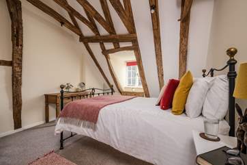 The exposed beams finish off this dreamy bedroom.