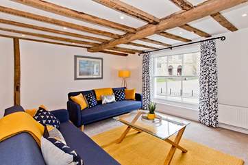Simply gorgeous, the sitting-room is light and bright with characterful beams and wide sash windows to take in the amazing view.