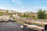 The fabulous deck has masses of space for both eating al fresco and sitting in the sun. Below the deck you'll find a small lawn.