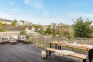 The fabulous deck has masses of space for both eating al fresco and sitting in the sun. Below the deck you'll find a small lawn.