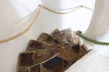 Beautifully crafted from local stone, the spiral staircase leads to the first floor.