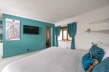 Bedroom 2 has a super-king double bed and fabulous artwork.
