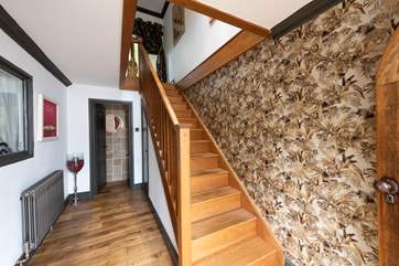 Polished wooden stairs take you up to the first floor.