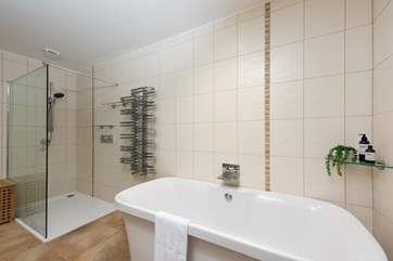 The family bathroom has a free-standing bath and a walk-in shower.