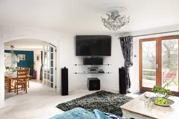 The sitting-room leads through partition doors into the dining area.