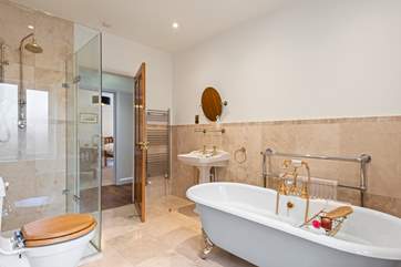 The en suite bathroom to bedroom 1 is gorgeous with a rainfall shower and roll-top bath for a long soak after a busy day.