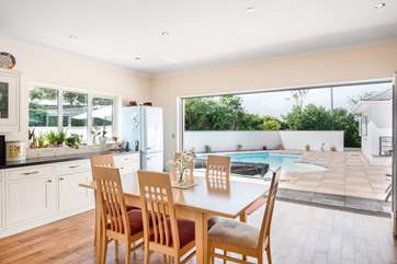 The bi-fold doors open out onto the pool from the second dining-area.