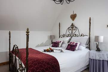 King size bed made up with fresh white linens.