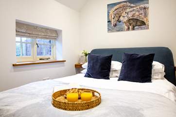 The gorgeous bedroom with king-size bed and luxury linens awaits.