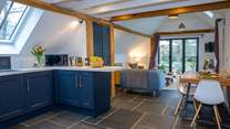 This barn conversion marries the traditional style of slate floors and exposed beams, with beautiful contemporary furnishings.