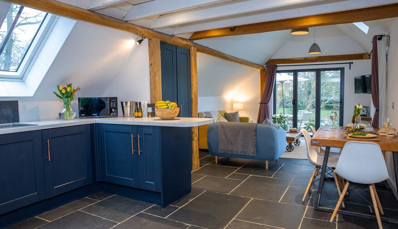 This barn conversion marries the traditional style of slate floors and exposed beams, with beautiful contemporary furnishings.