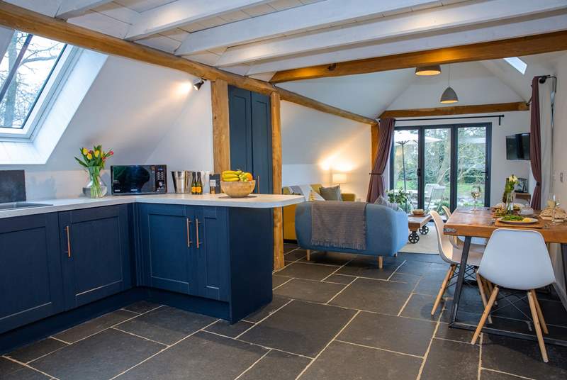 This barn conversion marries the traditional style of slate floors and exposed beams, with beautiful contemporary furnishings.