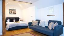 The gorgeous bedroom has oodles of space to relax and re-charge.