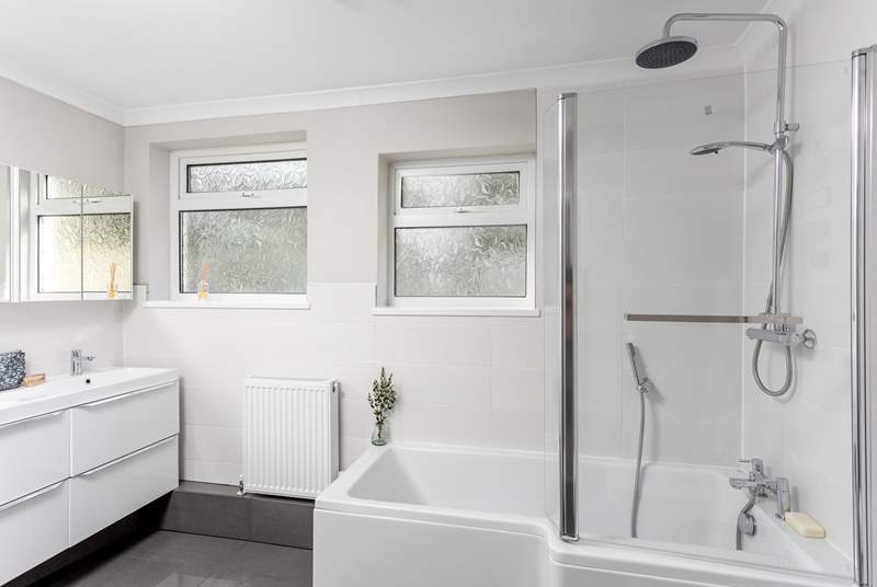 The family bathroom has oodles of space and an L-shaped bath for a relaxing soak.