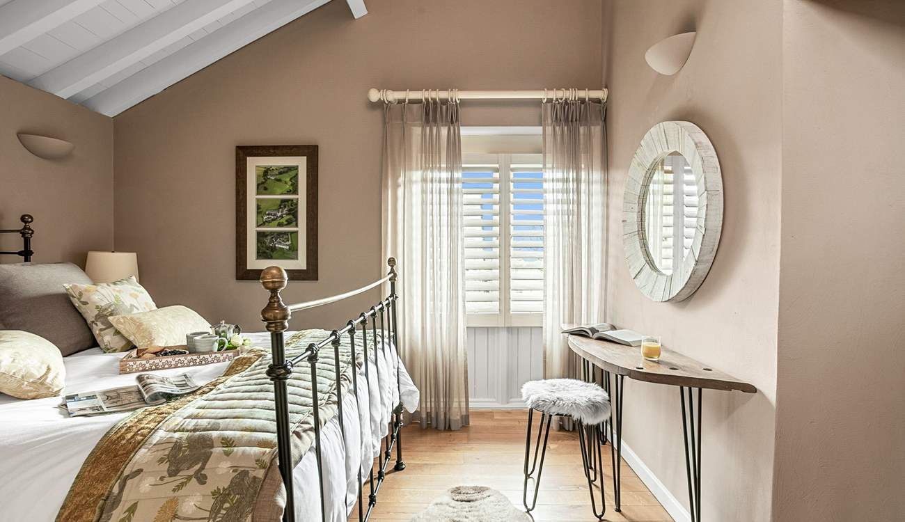 Bedroom two has beautiful high ceilings and luxurious finishing touches.