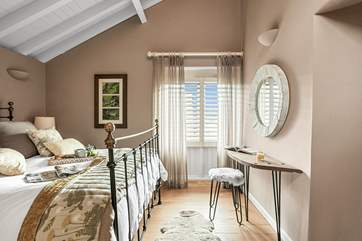 Bedroom two has beautiful high ceilings and luxurious finishing touches.