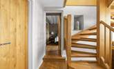 The downstairs hallway leads off to both bedrooms. - Thumbnail Image