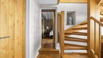 The downstairs hallway leads off to both bedrooms.