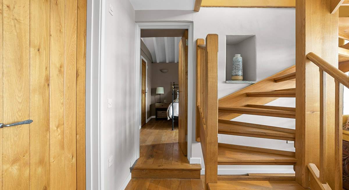 The downstairs hallway leads off to both bedrooms.