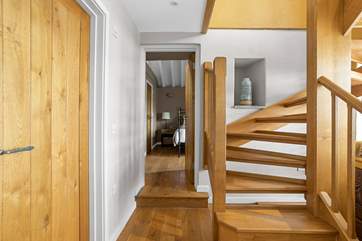 The downstairs hallway leads off to both bedrooms.