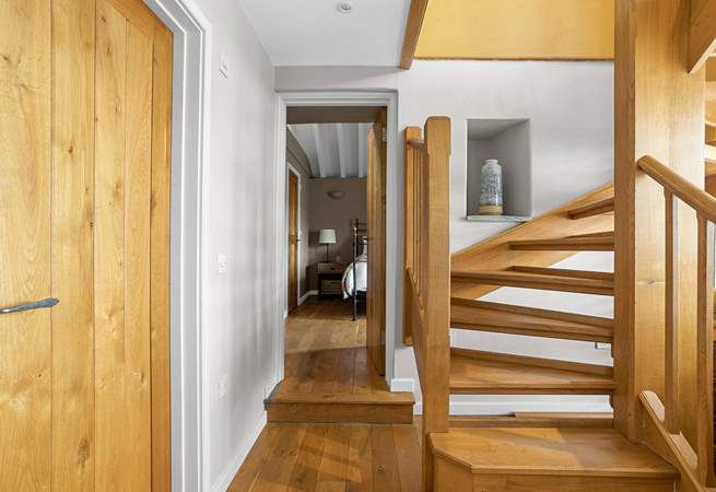 The downstairs hallway leads off to both bedrooms.